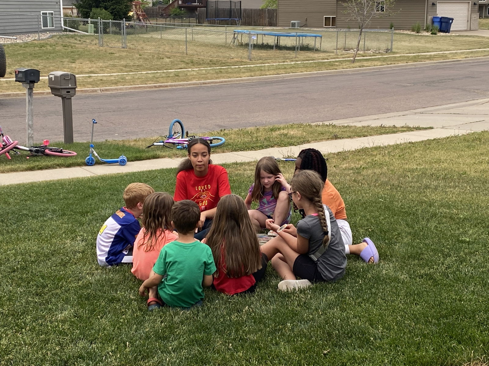 a gathering of children listening to a presentation