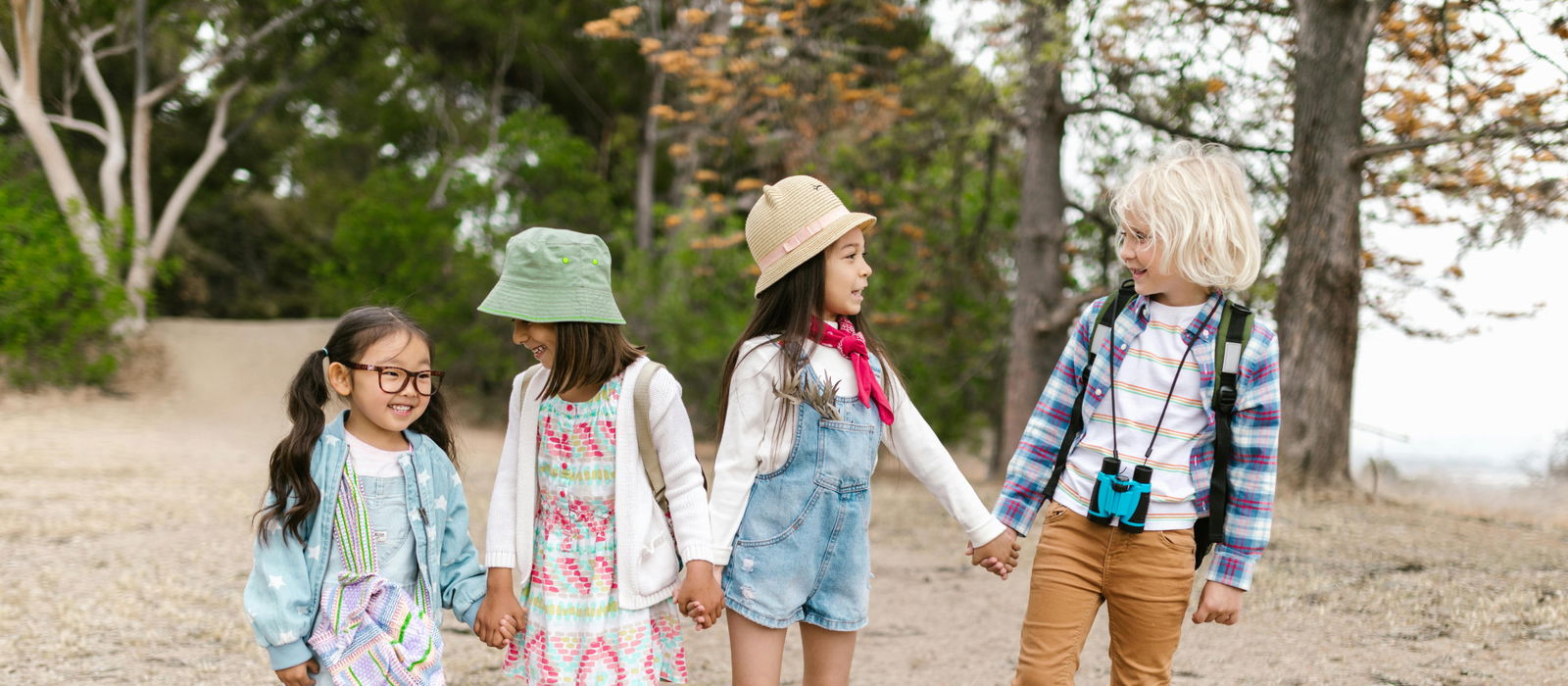 Children holding hands and hiking